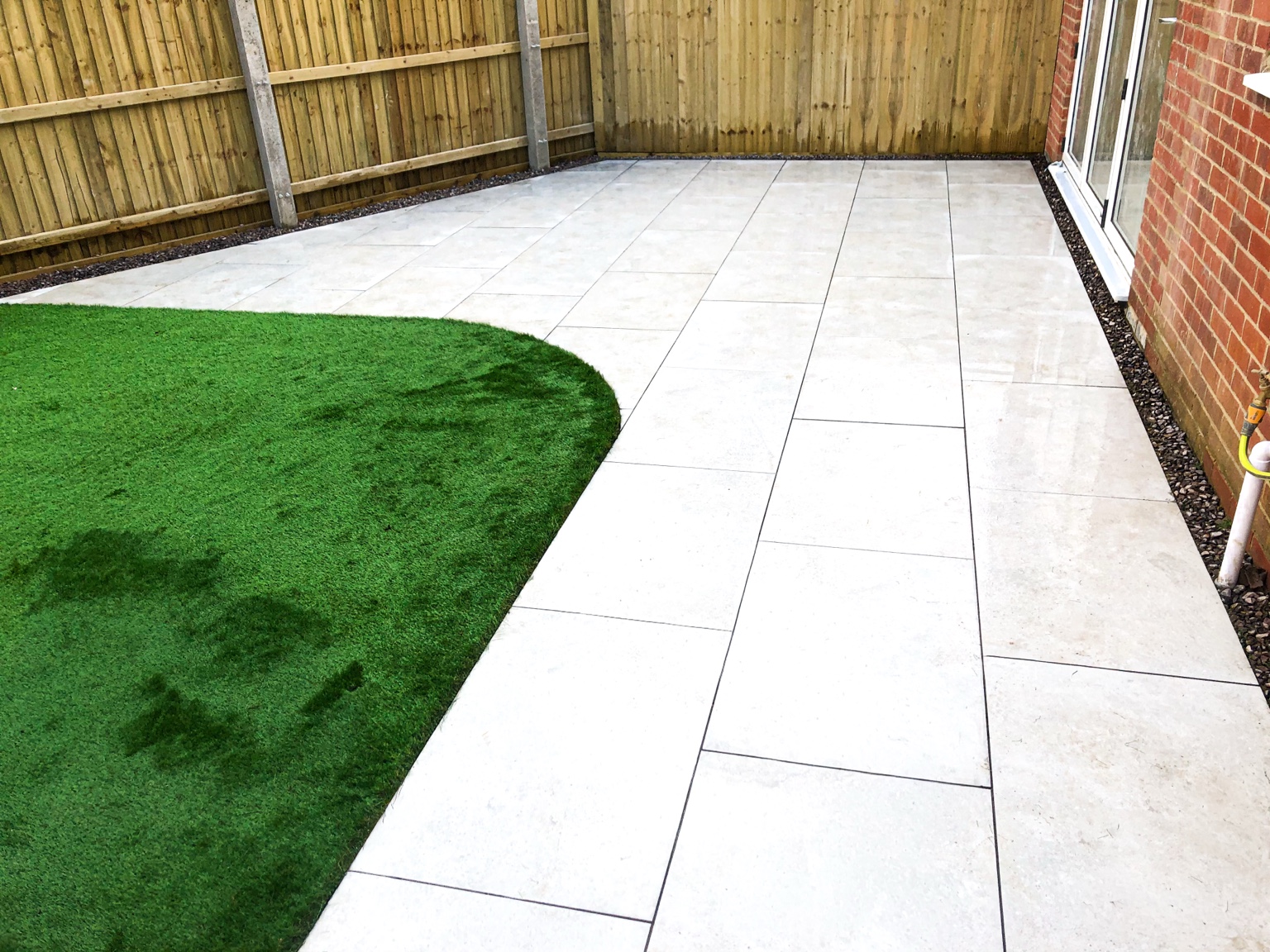 Porcelain Patio & Artificial Grass by Stonecrest Paving and Landscaping